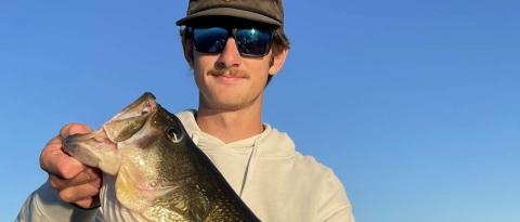 Image of fishing guide holding a fresh caught largemouth bass