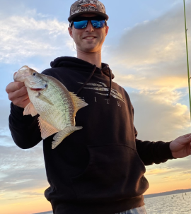 Image of fishing guide holding a fresh caught crappie fish