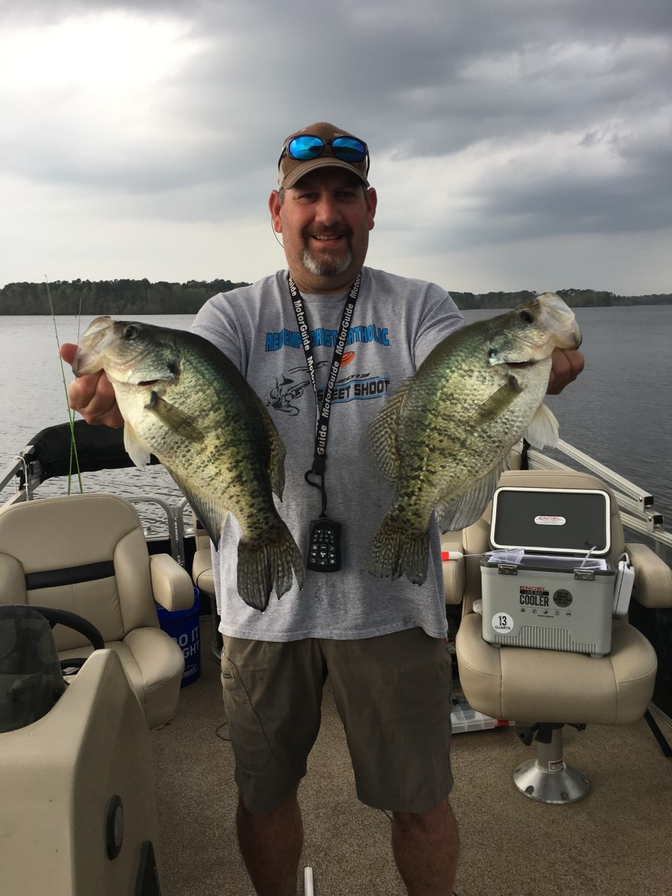 Image of fishing guide holding two fresh caught largemouth bass